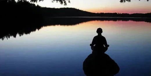 A serene individual practicing mindfulness outdoors, focusing on living in the present moment and embracing peace