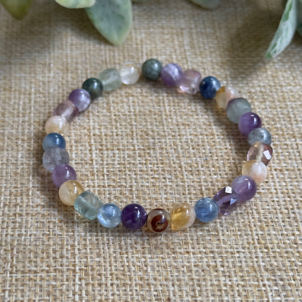  Close up of Conscious Evolution gemstone bracelet worn on left wrist for internal transformation energy.