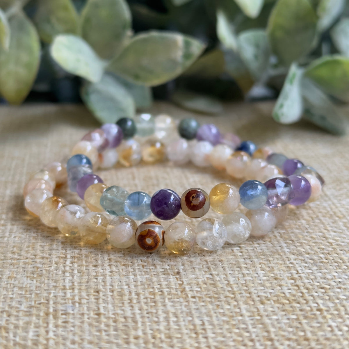 Conscious Evolution crystal bracelet on jewelry display card featuring Eckhart Tolle quote text.