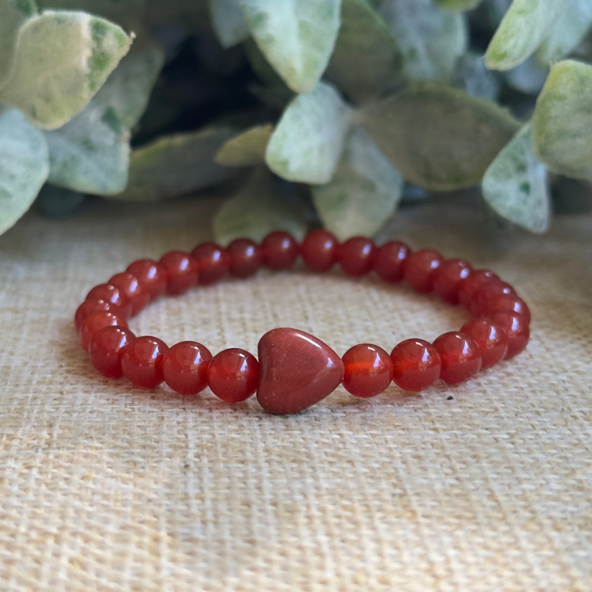 Dainty 6mm Red Carnelian beaded bracelet featuring a central red jasper heart bead.