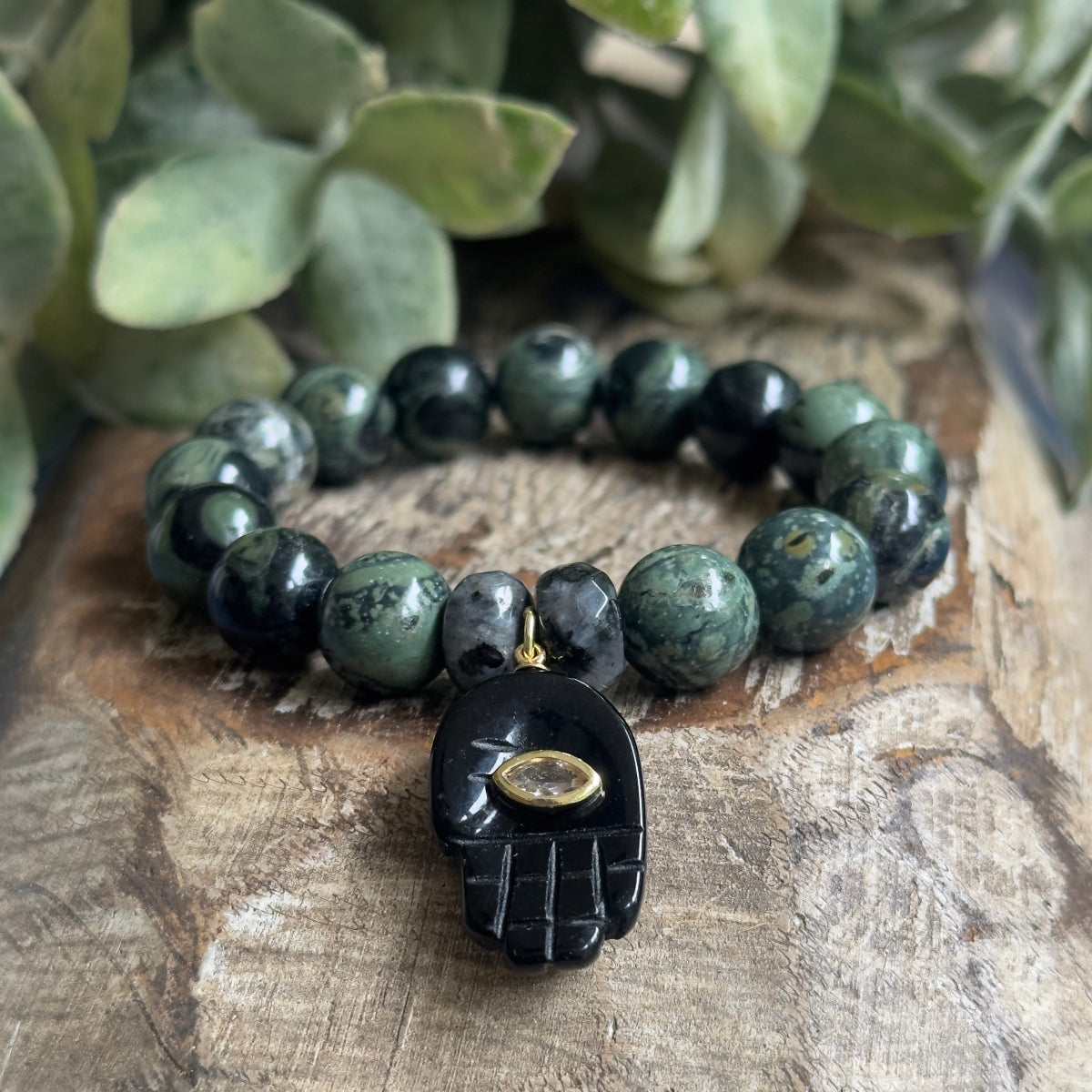 10mm Larvikite and Kambaba Jasper beaded stretch bracelet showing dark metallic flashes and green organic swirls on a neutral background.