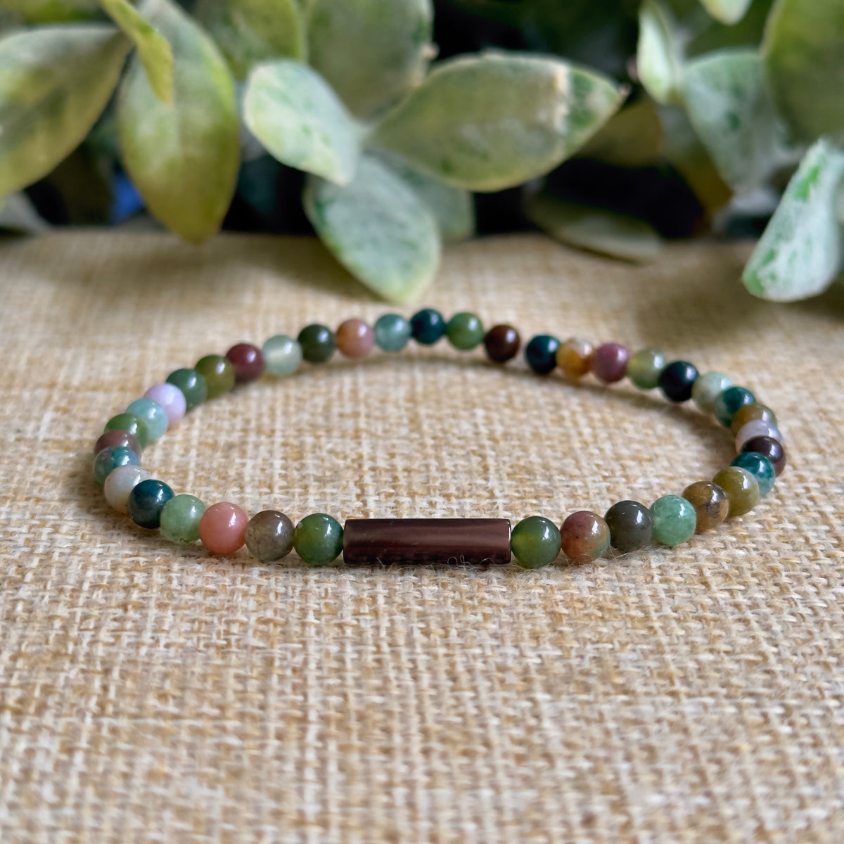 Sanctuary Indian Agate and brown Mother of Pearl tube bead bracelet on an earthy, natural background.