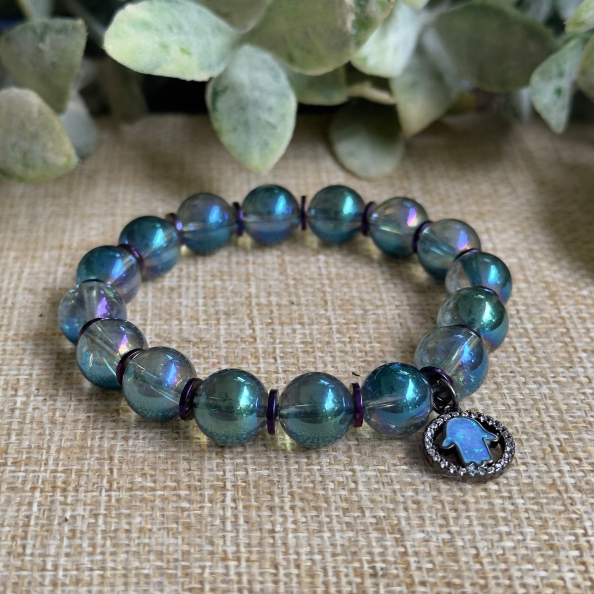 • Mystical autumn beaded bracelet with a glowing opal evil eye charm detail
