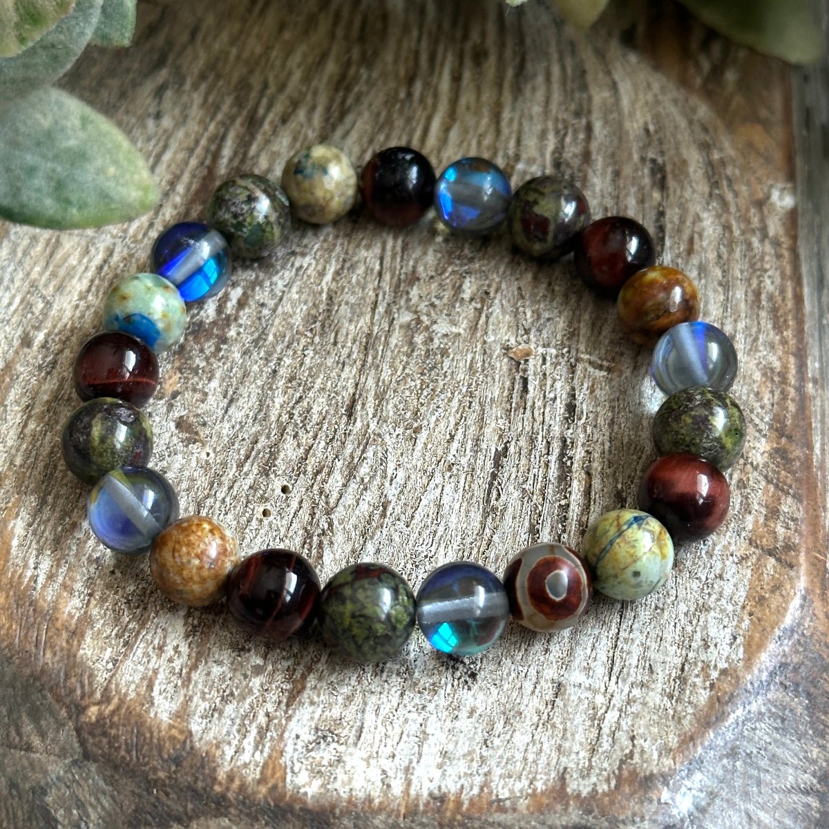 Healing crystal bracelet with Black Aura Quartz, Chrysocolla, Bloodstone and Tigers eye promoting resilience and inner peace. 