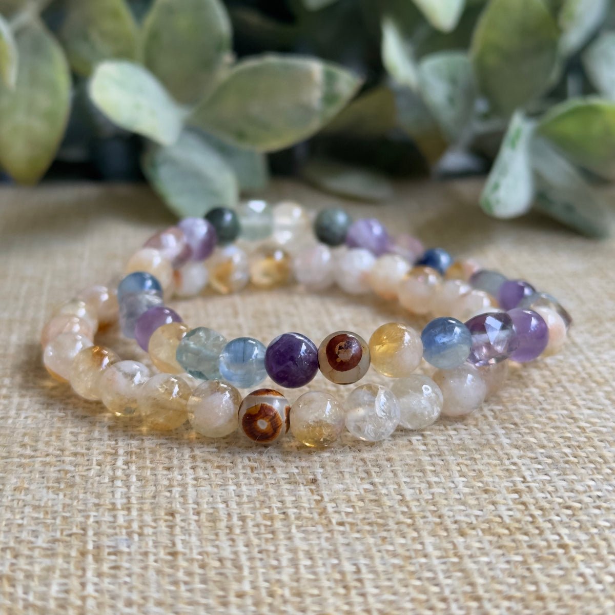 Conscious Evolution crystal bracelet on jewelry display card featuring Eckhart Tolle quote text.