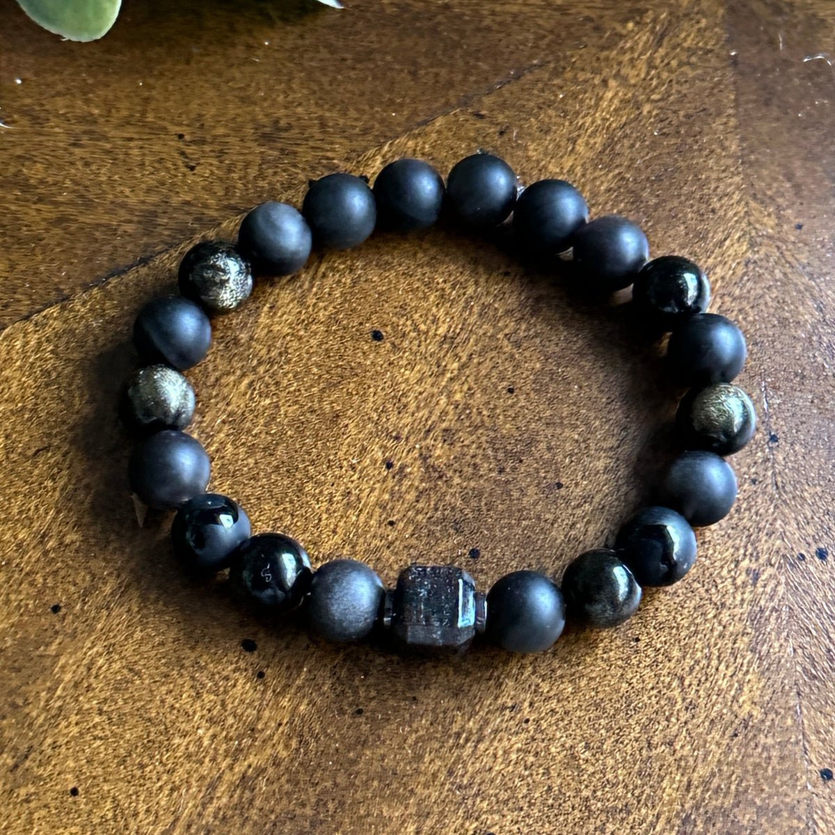 Textured black bracelet with inner glow, unisex energy jewelry.
