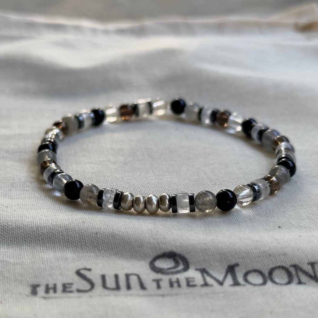 Divinely Protected protection bracelet featuring tiny 4mm smoky quartz, black onyx, and moonstone gemstone beads.