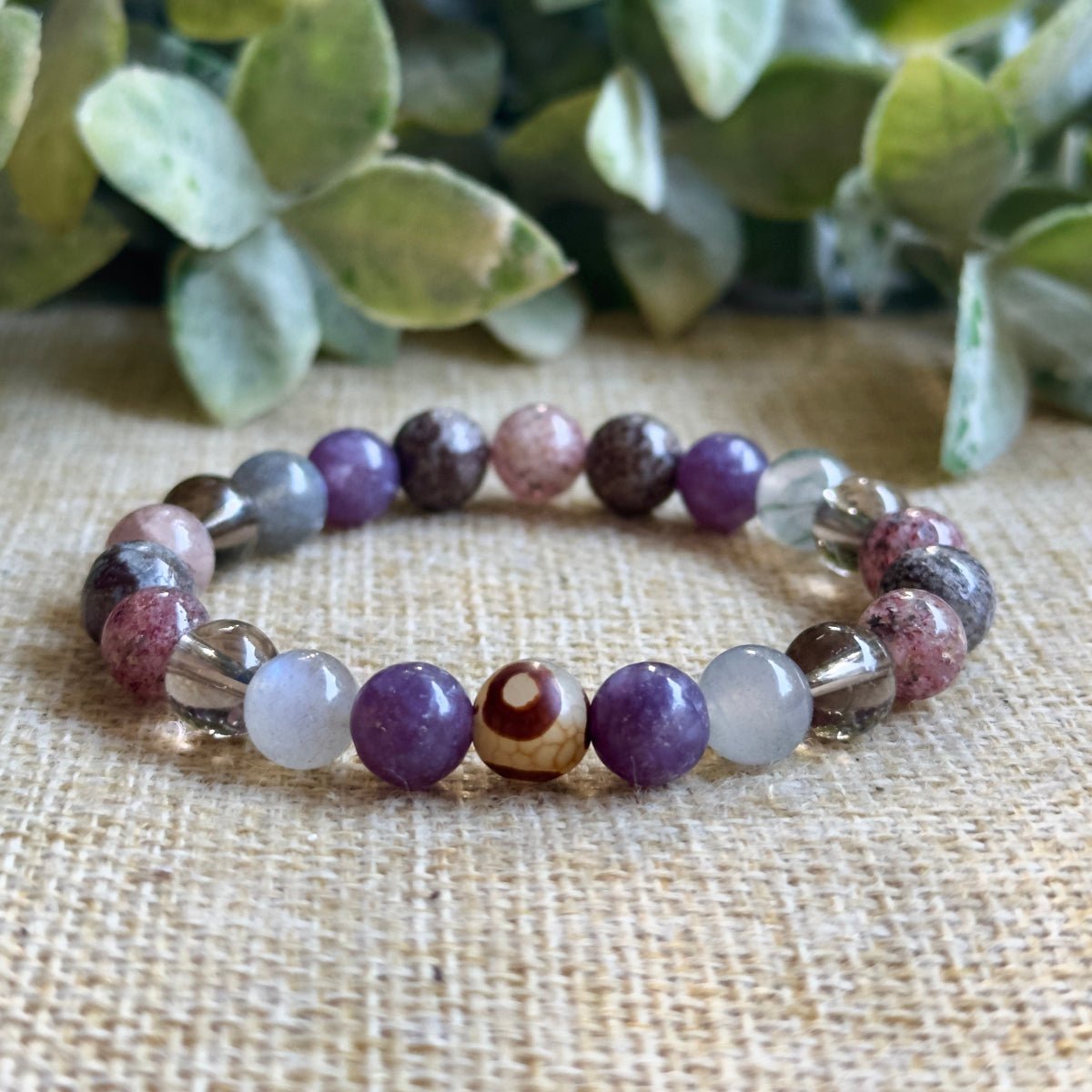 Empath Aura Shield crystal bracelet featuring lepidolite, labradorite, smoky quartz, strawberry quartz, and brown snowflake obsidian beads