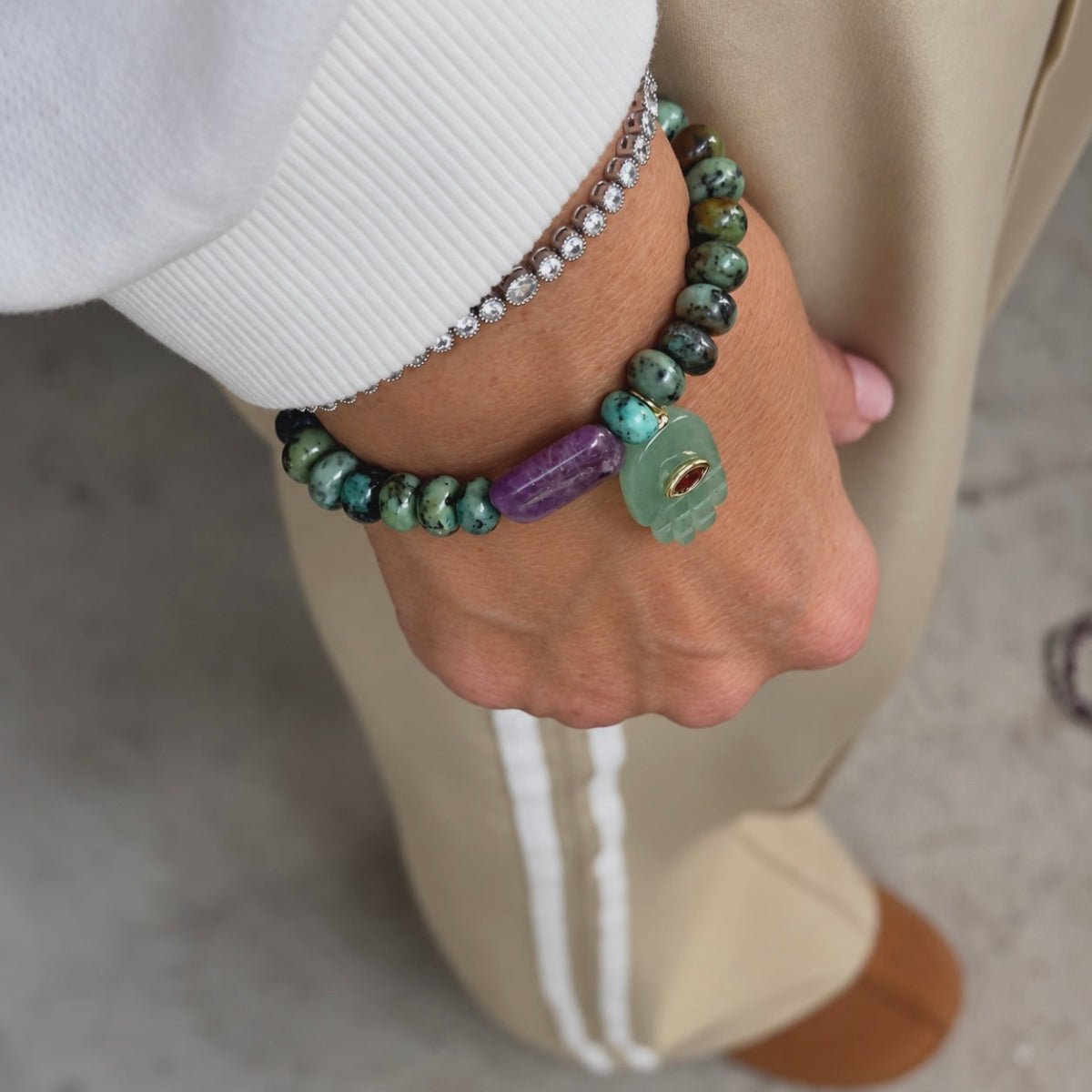 Stacked beaded gemstone bracelets for heart chakra healing, abundance, and inner peace.