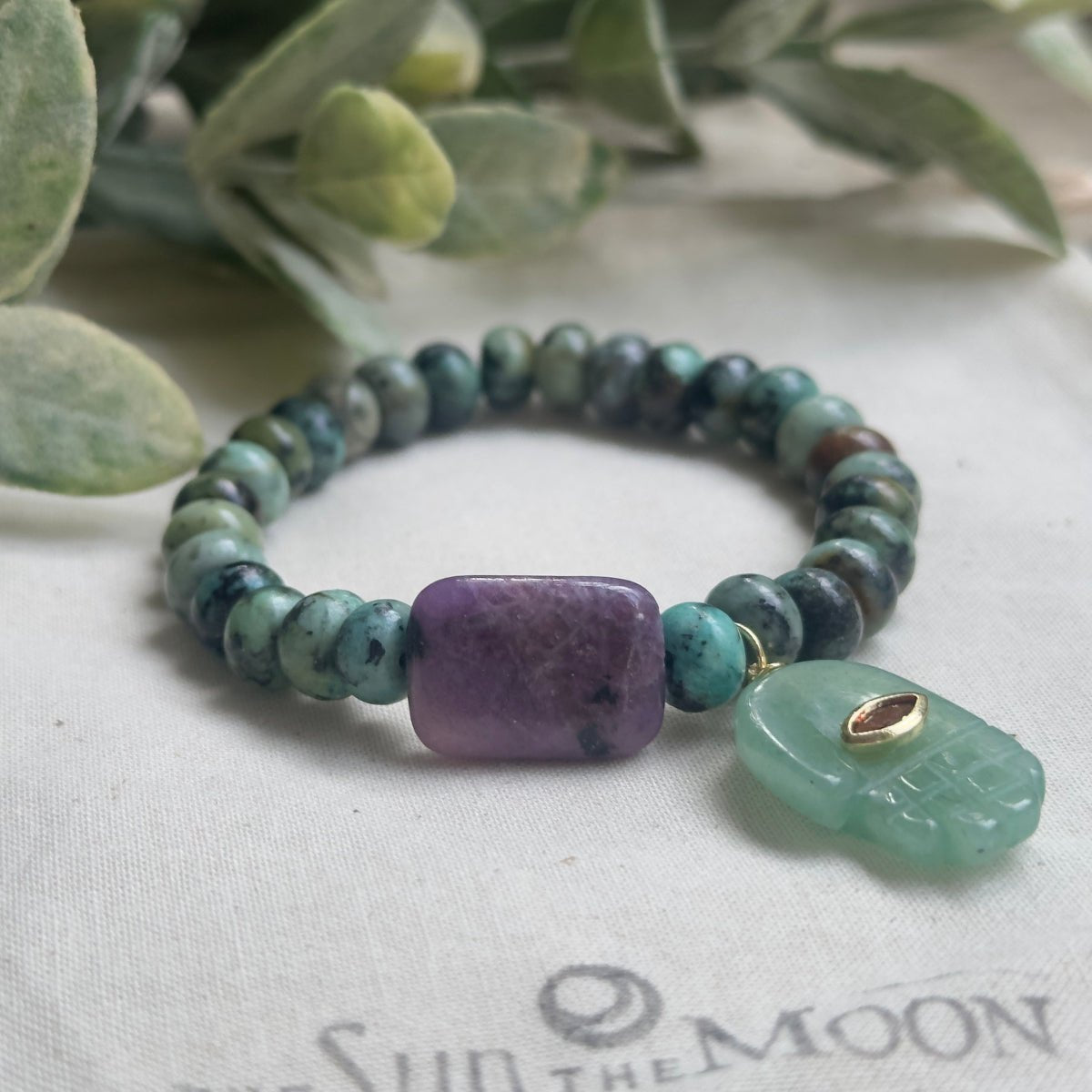 Green and purple crystal healing bracelet for anxiety relief, transformation, and good luck.