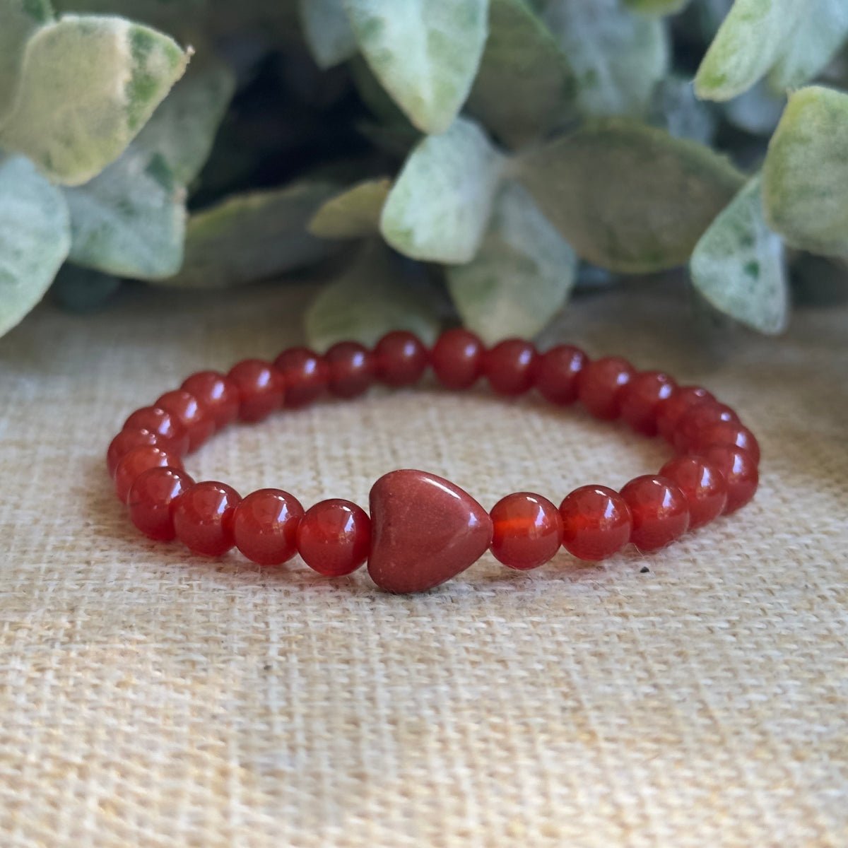 Dainty 6mm Red Carnelian beaded bracelet featuring a central red jasper heart bead.