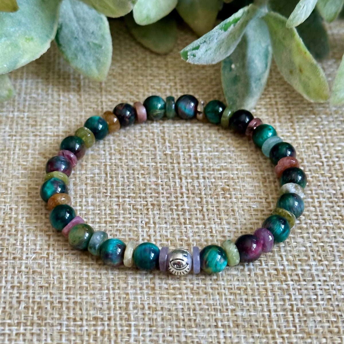 Jewel tone gemstone bracelet with silver evil eye charm
Tourmaline and tiger eye chakra bracelet handmade jewelry