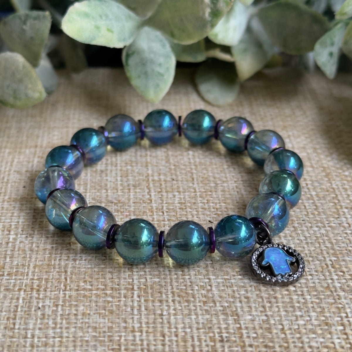 • Mystical autumn beaded bracelet with a glowing opal evil eye charm detail
