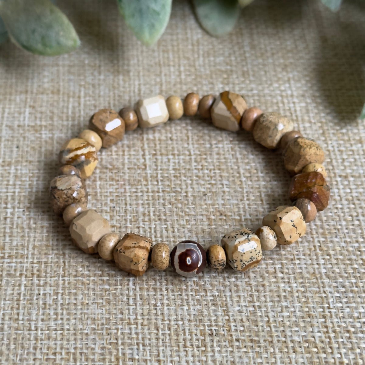 Close up of 8mm polished picture jasper crystal beads on an elastic bracelet