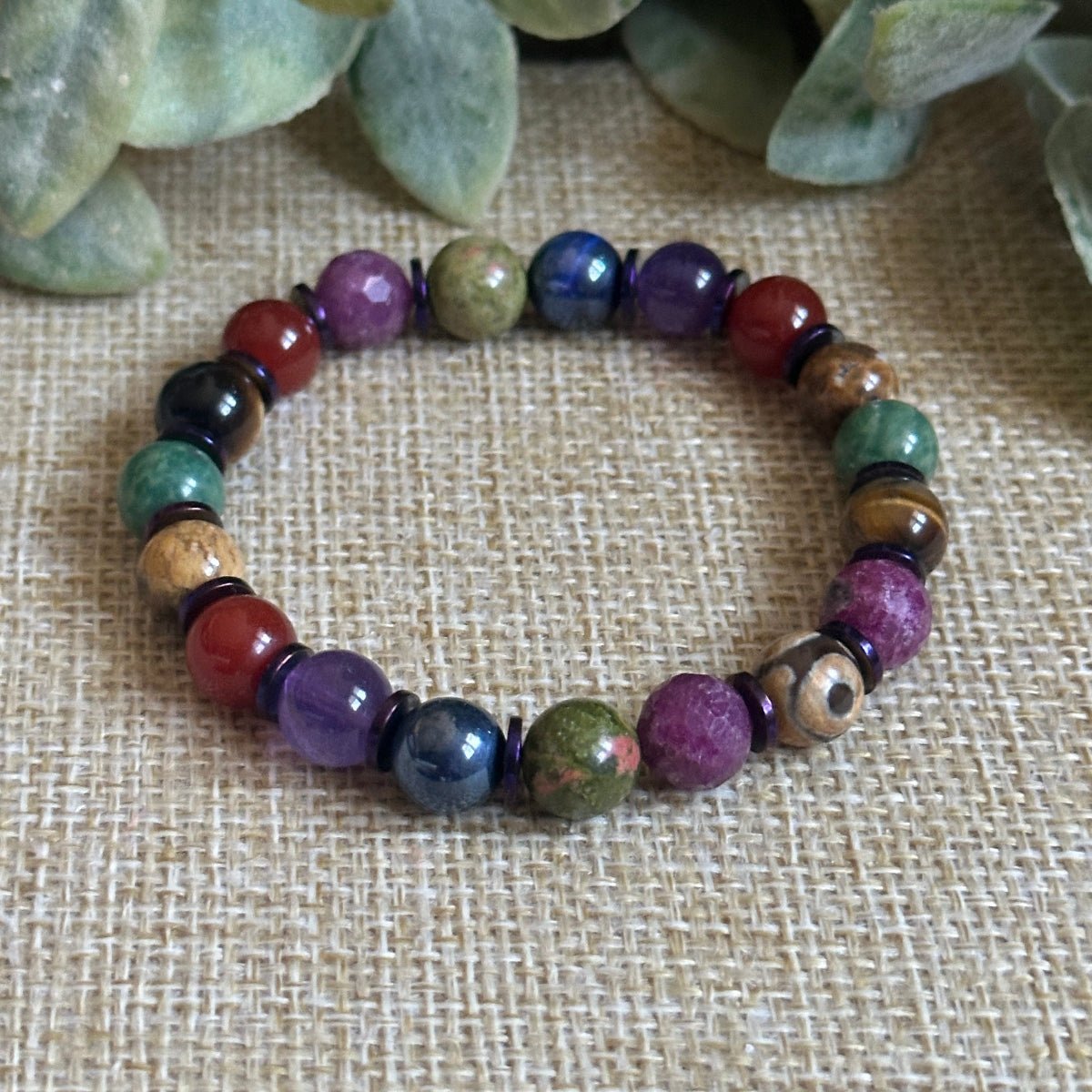 Jewel tone gemstone seven chakra bracelet with DZI Agate for protection