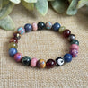 Mosaic gemstone bracelet featuring garnet, jasper, rhodonite, and dumortierite for grounding and growth