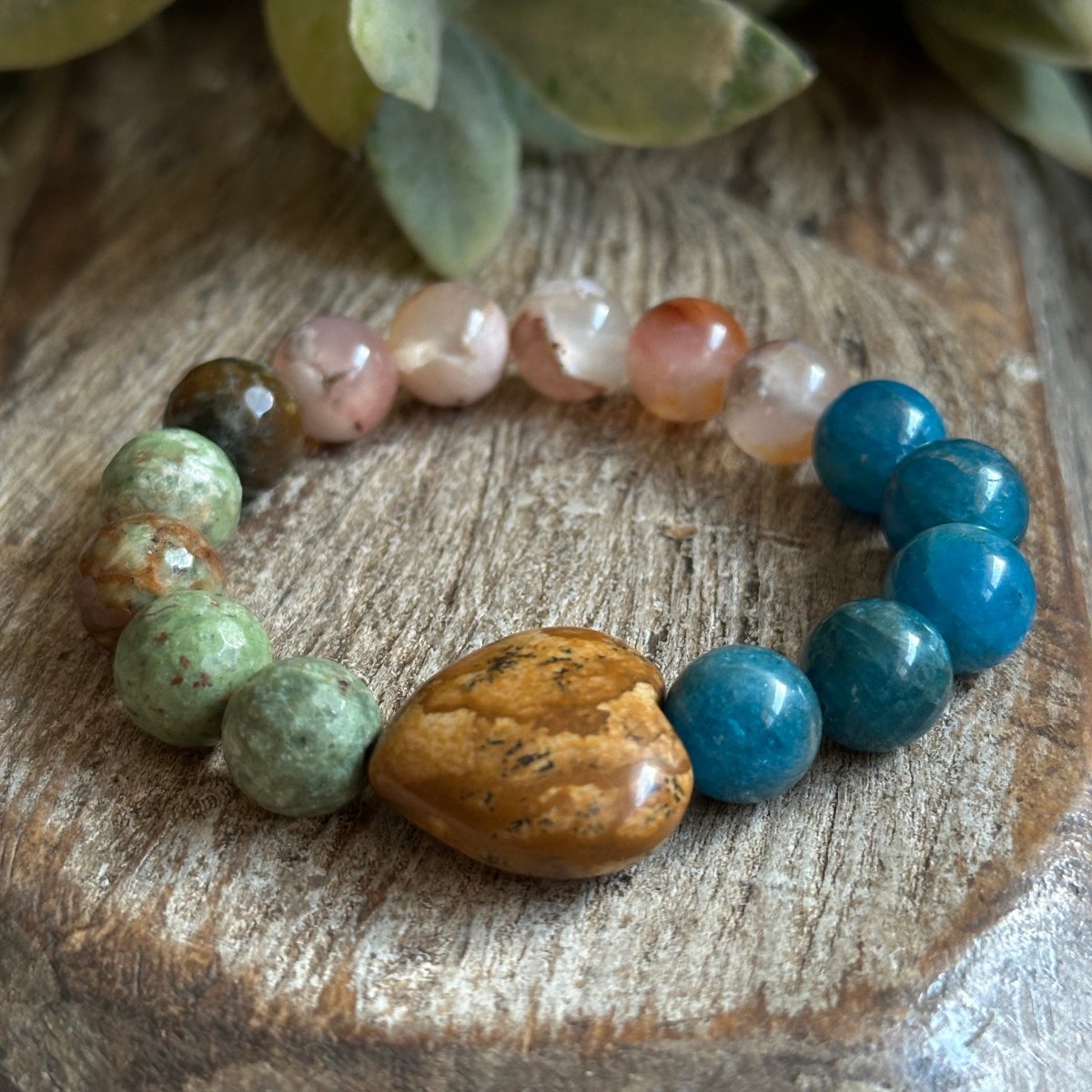 Storymaker bracelet wit h10mm Gemstones and a large heart focal stone.  With agate, Jasper and opa. For Manifestation and new beginnings